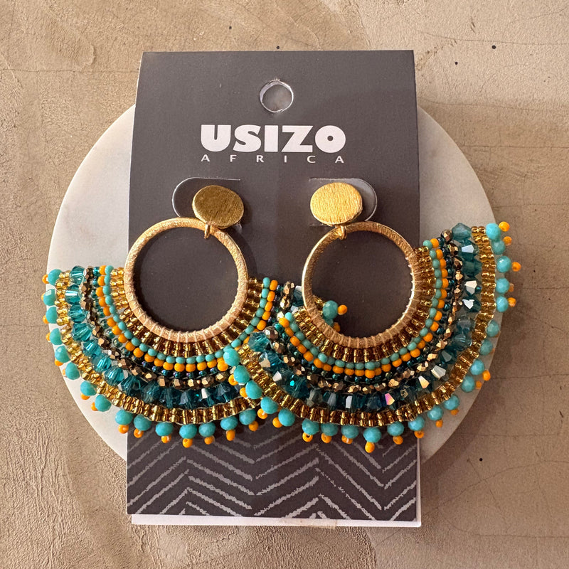 Pair of beaded earrings on a Usizo Africa branded card against a beige background