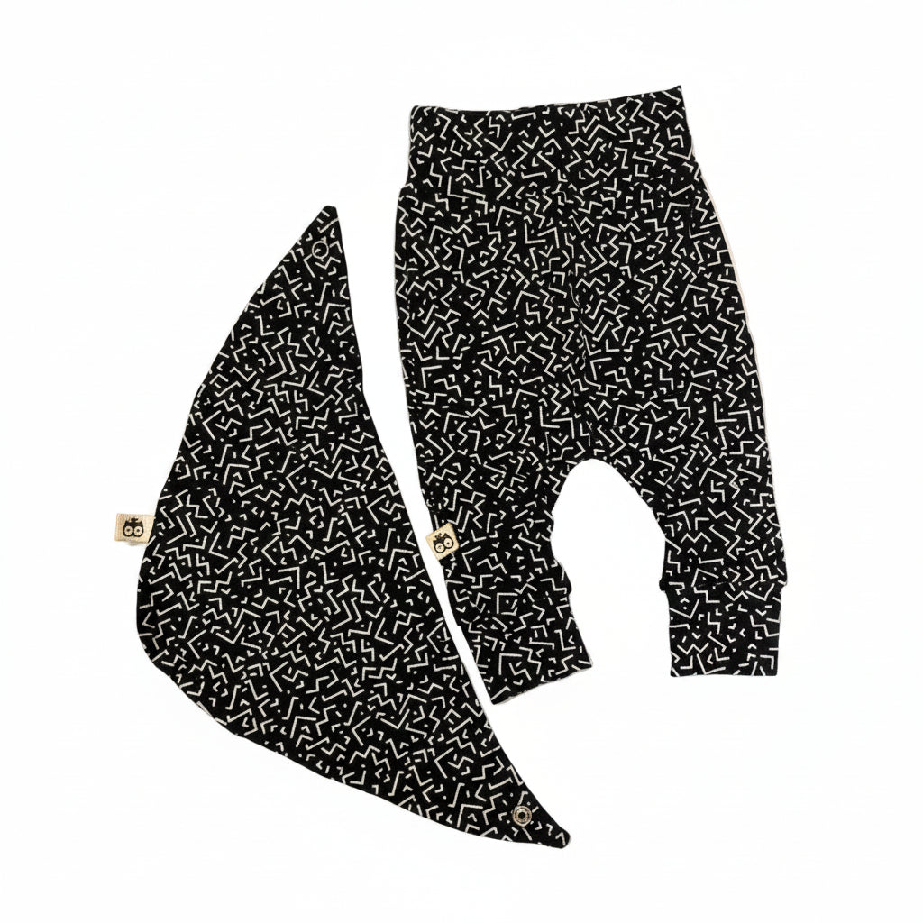 Black pants with white geometric pattern on a white background