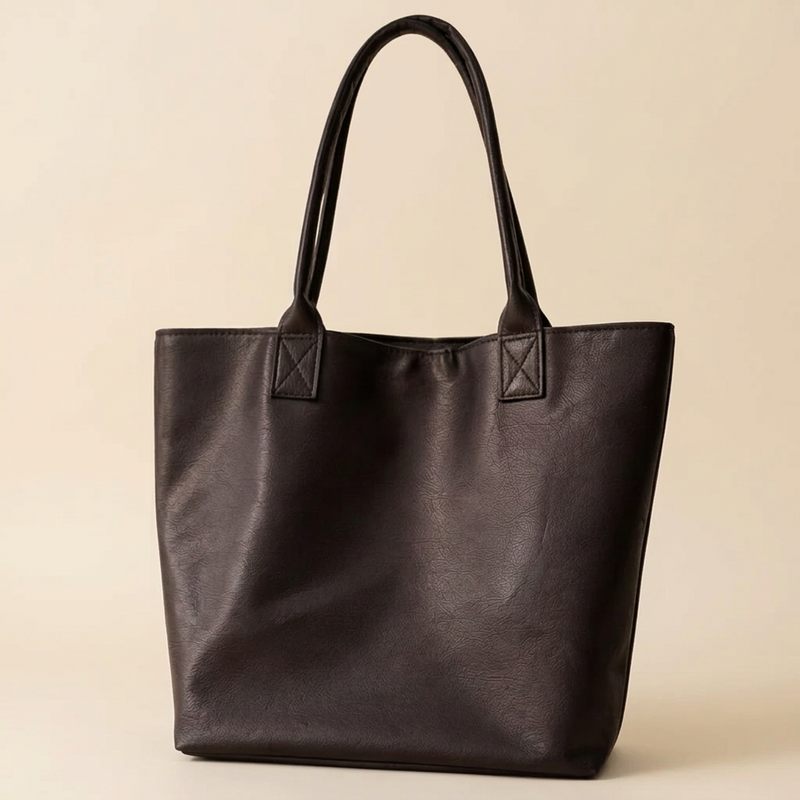 Black tote bag with a tag on a neutral background