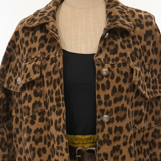 Leopard print jacket on a mannequin with a black top and yellow pants in a store setting.