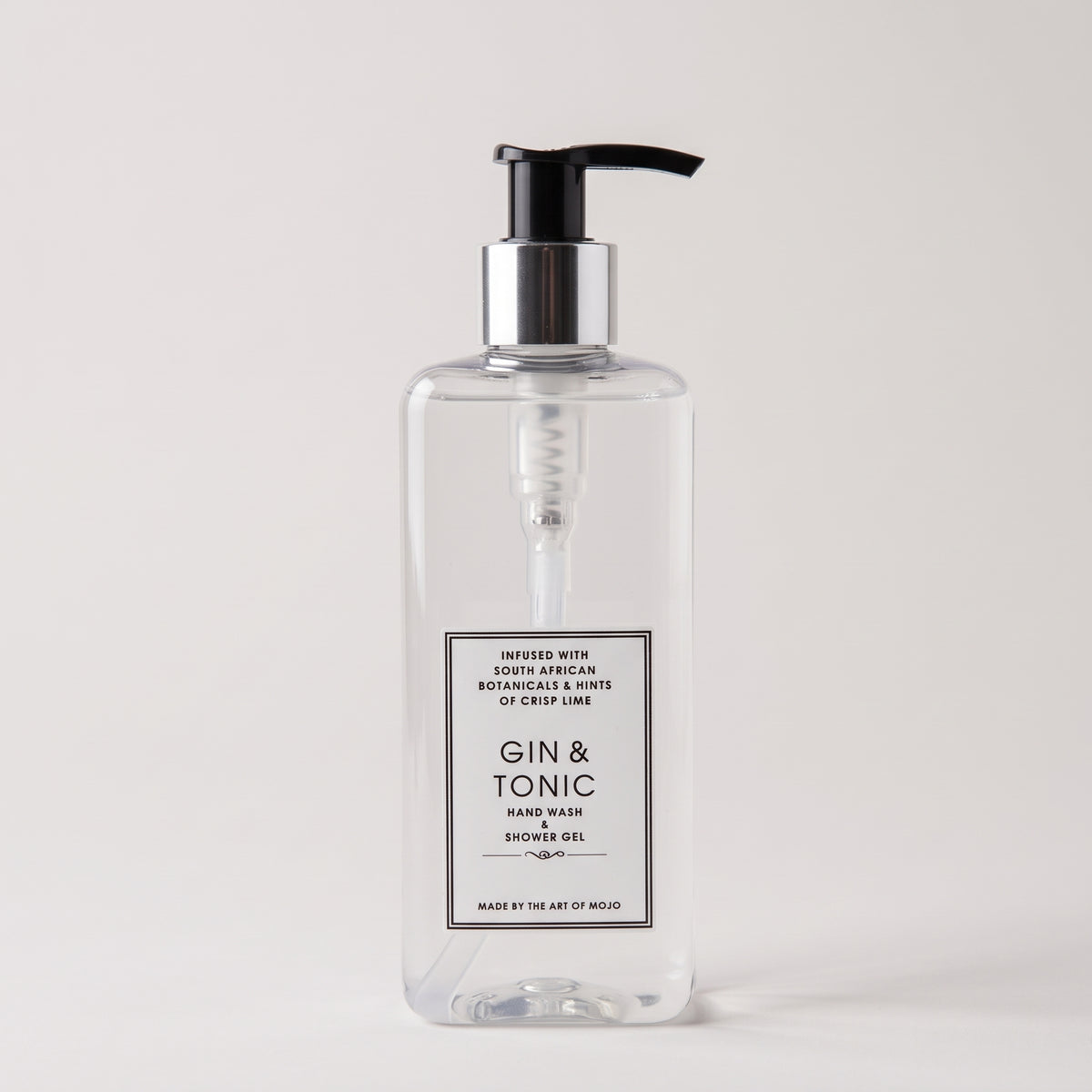 A clear rectangular pump bottle of Gin & Tonic hand wash shower gel with a black pump and silver collar, shown on a light gray background.