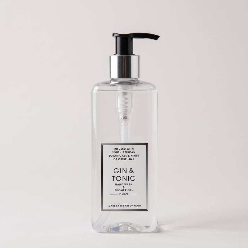 A clear rectangular pump bottle of Gin & Tonic hand wash shower gel with a black pump and silver collar, shown on a light gray background.