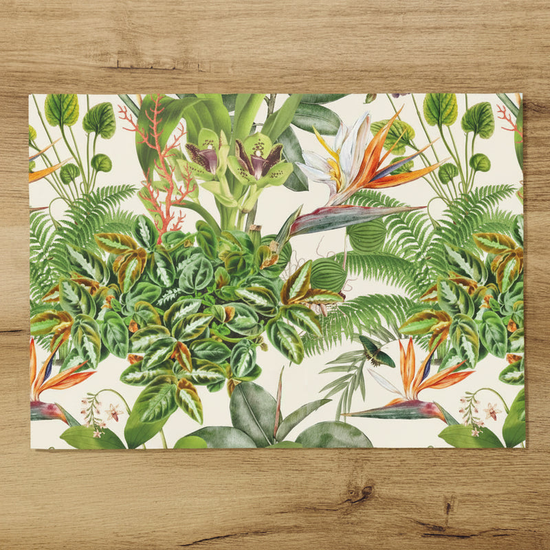Placemat with tropical plant design on a wooden table with a mug and spoon.