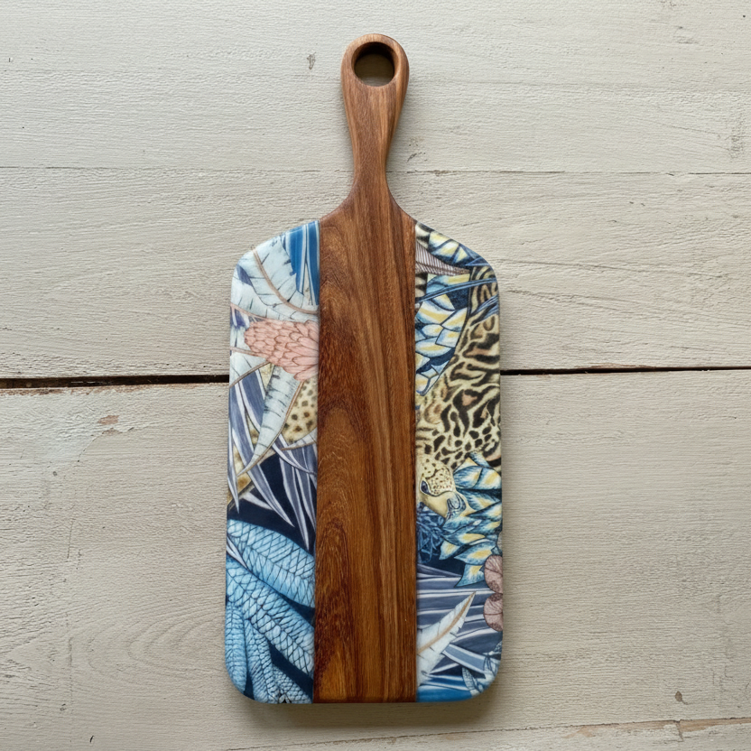 Wooden cutting board with Ardmore design on a wooden surface