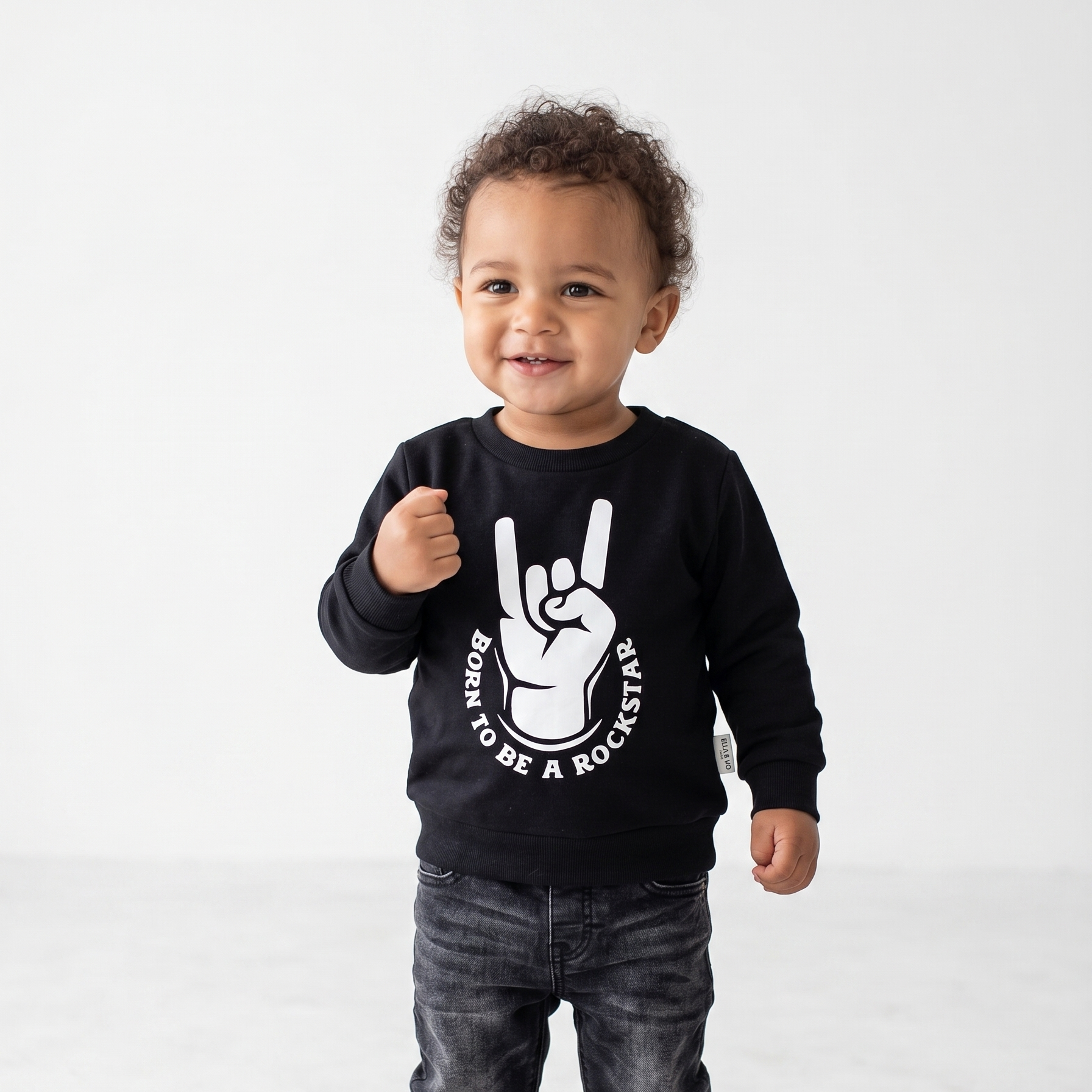 Child wearing a black sweatshirt with a graphic design on a white background