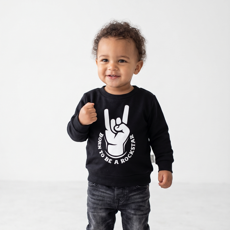 Child wearing a black sweatshirt with a graphic design on a white background