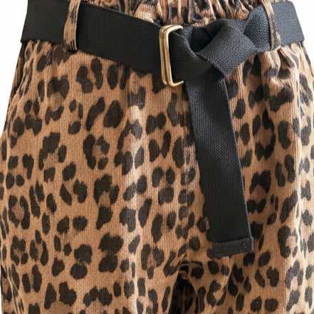 Leopard print pants with a black belt on a mannequin against a light background