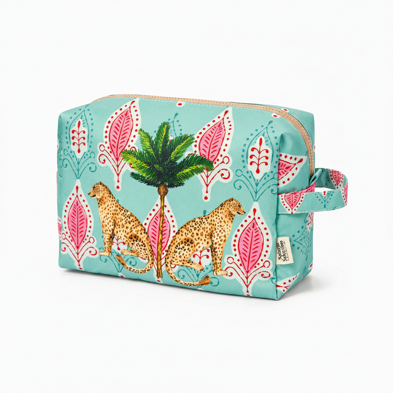A rectangular zippered pouch with a turquoise background, featuring a pattern of pink and white ornamental leaves, a green palm tree, and two spotted cheetahs. The pouch has a light beige zipper and a matching handle, shown on a clean white background.