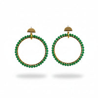 Green beaded hoop earrings on a Usizo Africa branded card against a beige background
