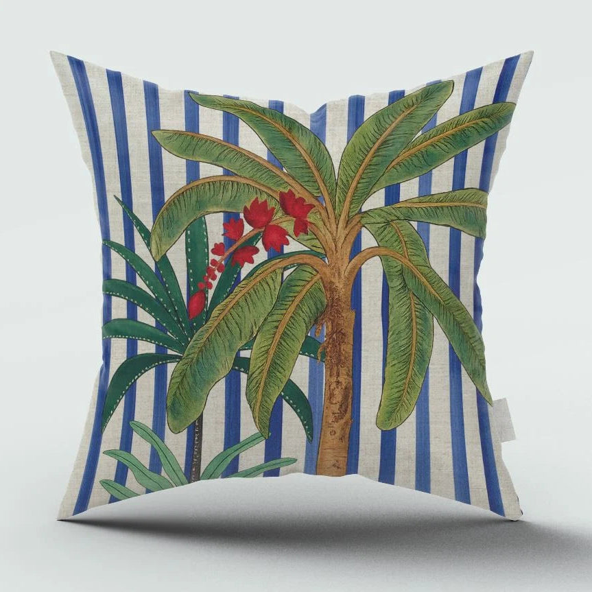 Decorative pillow with palm tree and striped pattern on a white background