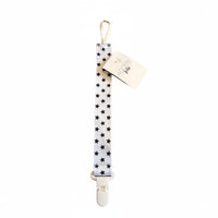 Star-patterned strap with a clip on a textured surface