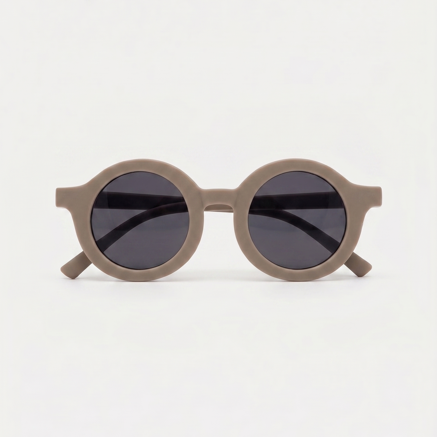 Round sunglasses with dark lenses on a light gray background