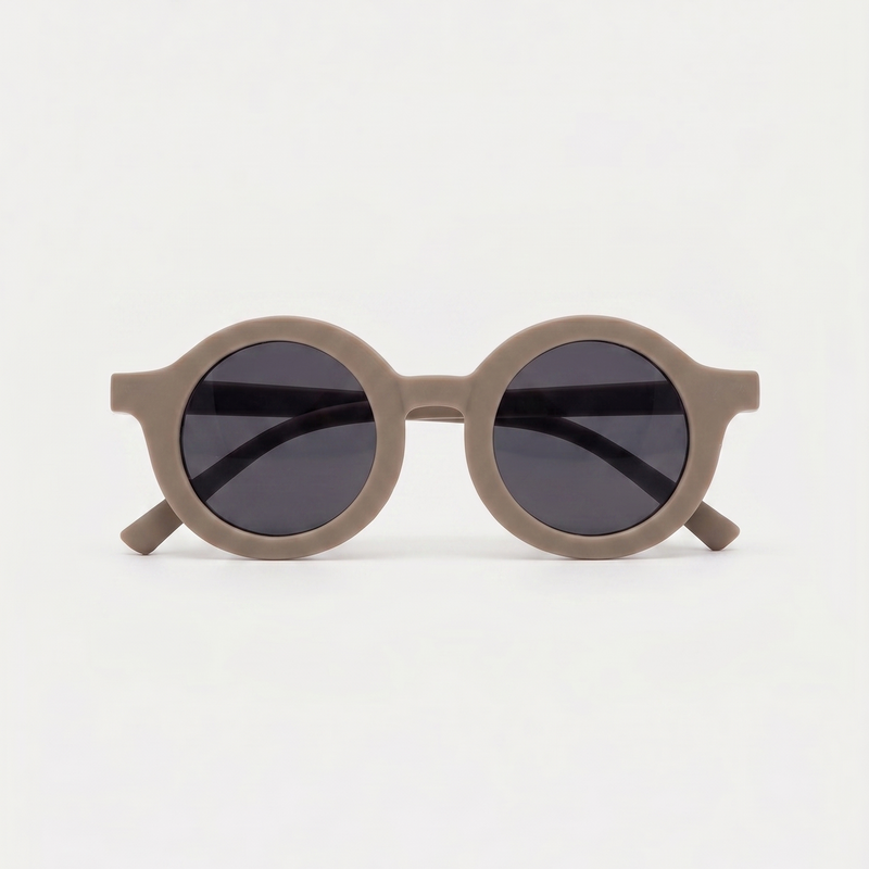 Round sunglasses with dark lenses on a light gray background