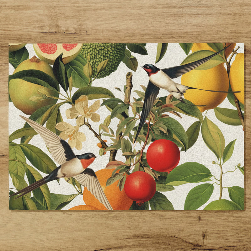 Placemat with bird and fruit design on a wooden surface.
