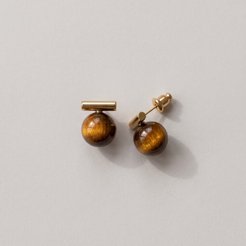 A pair of gold-toned stud earrings with round brown tiger's eye beads, displayed on a light gray background.