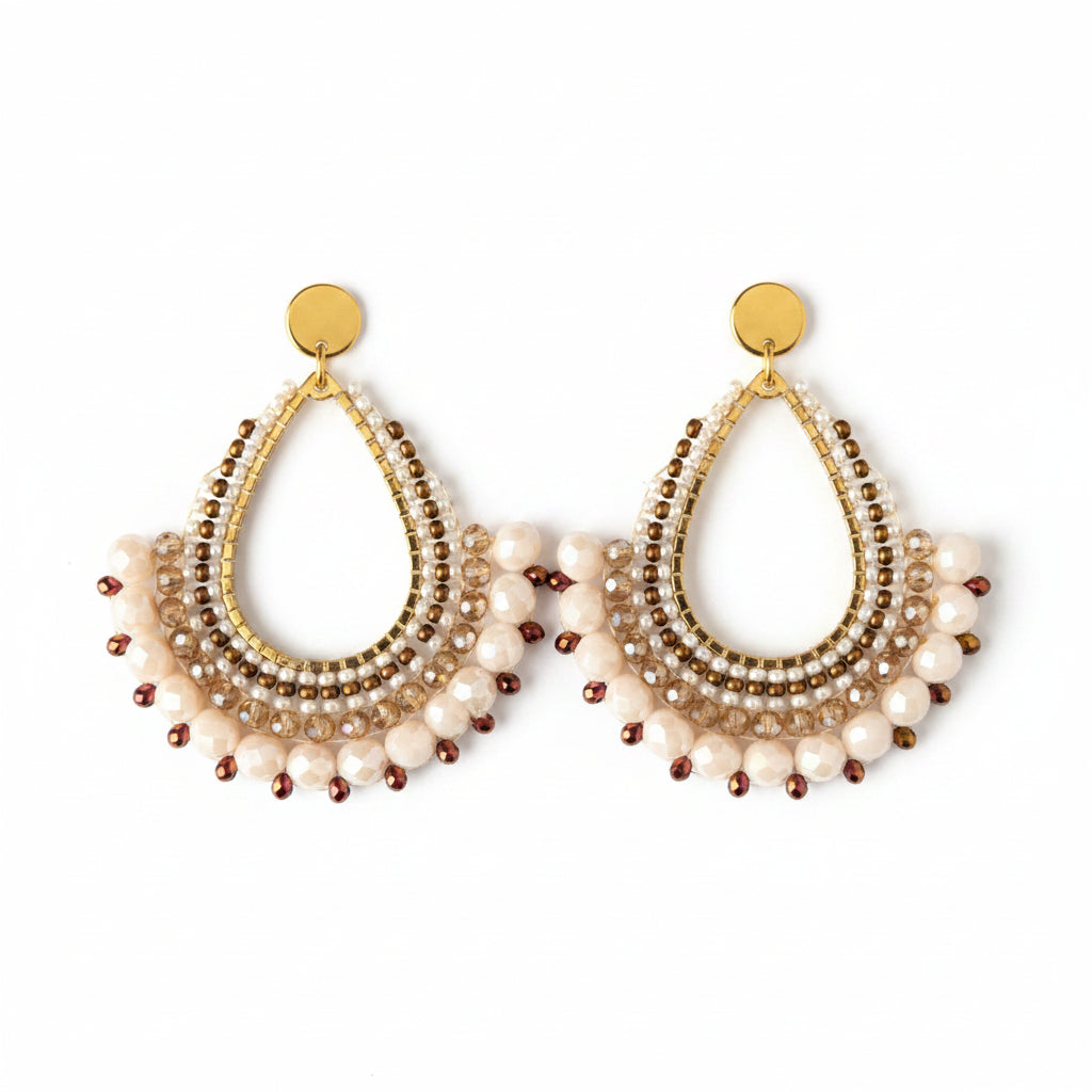 Pair of gold and beaded earrings on a 'Usizo Africa' branded card against a beige background.