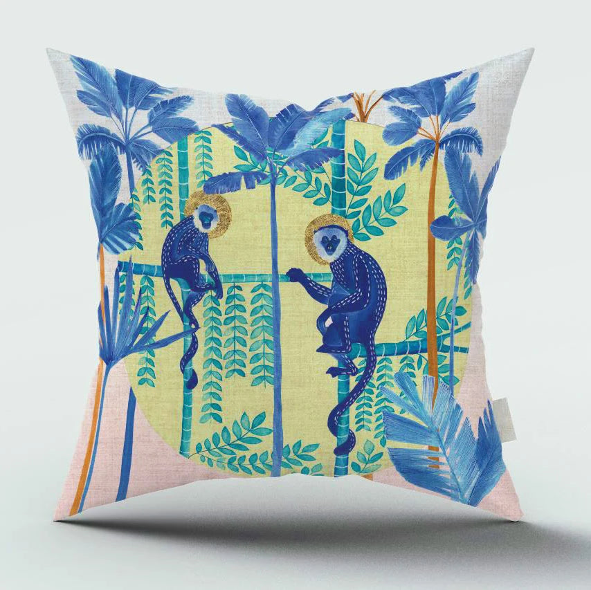 Decorative pillow with monkeys and tropical leaves design on a white background