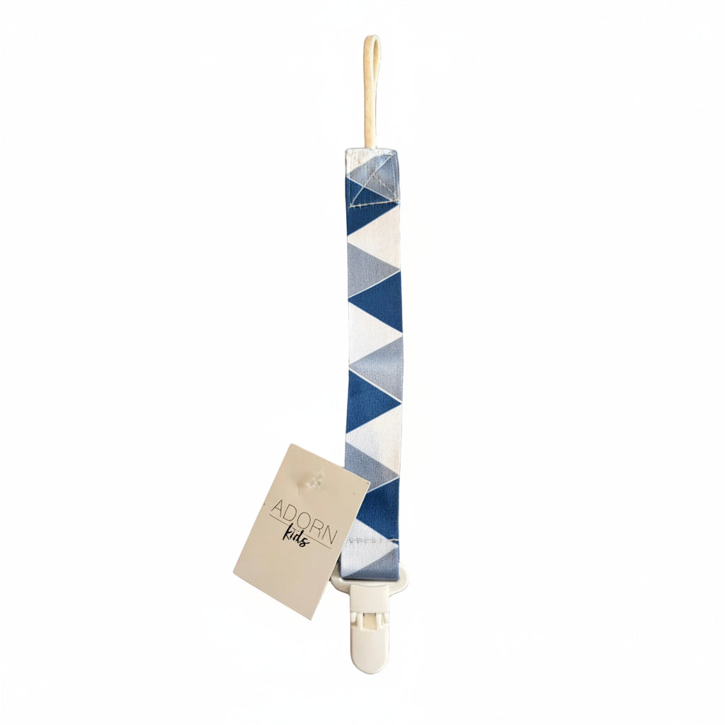 Blue and white geometric patterned strap with a tag on a brown surface