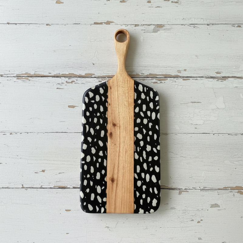 Cheese board with white spots on black print.